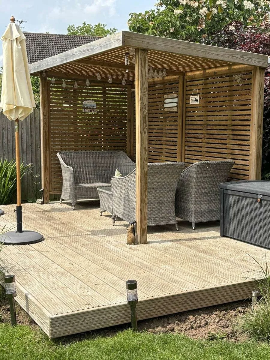 Corner pergola with slatted sides on a timber deck