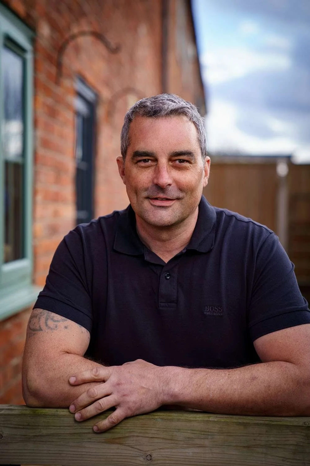 Steve, the owner, leaning on a timber fence